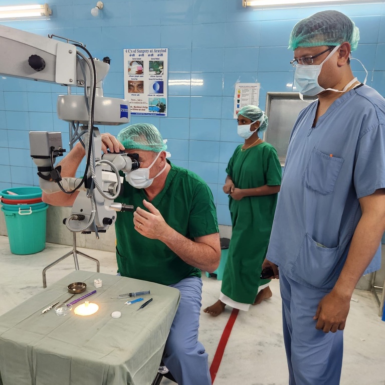 Greg Schmidt looking through a scope while training at Aravind Eye Hospital in Pondicherry, India.